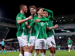 Dion Charles, with arms outstretched, celebrates his goal with Northern Ireland team-mates