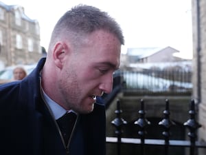 Side view headshot of Stuart Hogg entering court