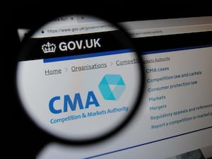 The Competition and Markets Authority website seen through a magnifying glass