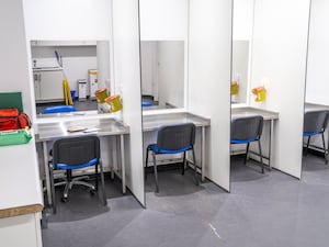 View of a safe consumption room, with individual desks separated by partitioning