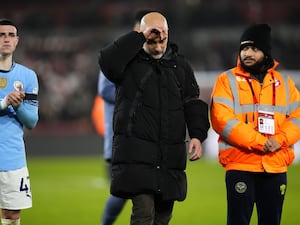 Pep Guardiola puts his hand to his head in disbelief