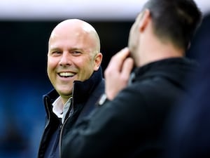 Liverpool manager Arne Slot smiles on the touchline