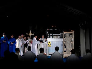 Paris archbishop Laurent Ulrich, centre, conducts a blessing ceremony next to the original Virgin Mary statue, right, which did not suffer from the 2019 fire, before its return in the Notre Dame Cathedral