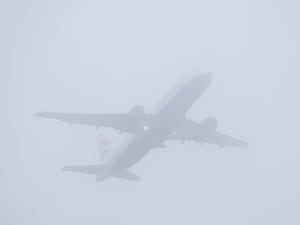 A plane takes off from Gatwick Airport in misty conditions