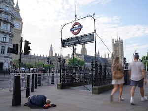 A homeless person asleep on the street