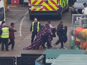 People disembark from a Border Force boat at Dover