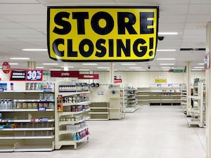 A shop interior with a sign reading 'store closing' hanging from the ceiling