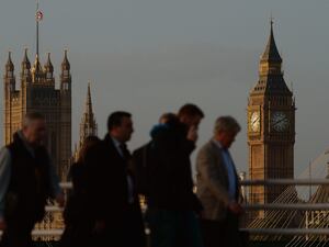 Commuters walk in London with Big Ben in the background