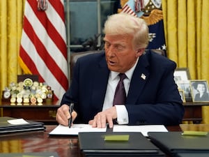 President Donald Trump signs an executive order on TikTok in the Oval Office of the White House