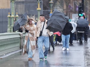 People walking in the wind and rain on Westminster Bridge, London