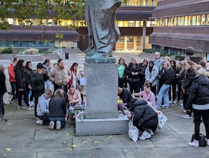 Fans pay their respect to Liam Payne at the Lady Wulfruna statue