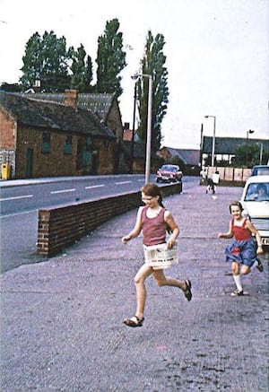 Lena Holmes asks if anyone recognises the village or her daughters in this old photo