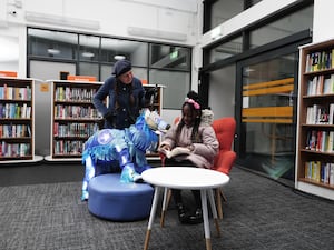 Pearl Ogunyadeka, 10, reading a book inside Spellow Community Hub and Library in Walton, Liverpool, ahead of its reopening on Wednesday night