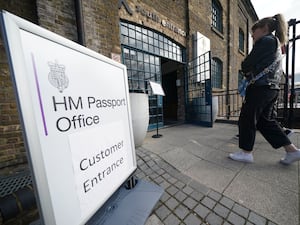 A Passport Office sign as a person walks past