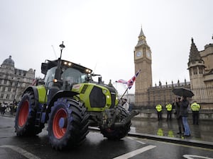 A tractor drives past Big Ben during a farmers' protest in Westminster.