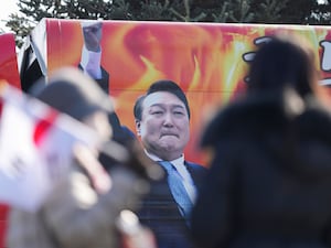 A picture of impeached South Korean President Yoon Suk Yeol is seen on a vehicle during a rally to oppose his impeachment outside of a detention centre in Uiwang, South Korea on Friday