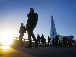 People walk at dawn in the City of London