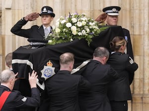 Police salute as the coffin is carried into York Minister for the funeral of constable Rosie Prior