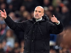 Pep Guardiola holds his arms out in frustration