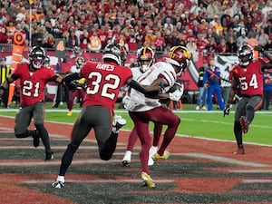 Washington Commanders wide receiver Terry McLaurin, middle, catches a touchdown pass in front of Tampa Bay Buccaneers safety Josh Hayes