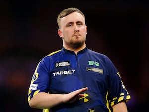 Luke Littler reacts after winning the eighth set during the Paddy Power World Darts Championship final against Michael van Gerwen