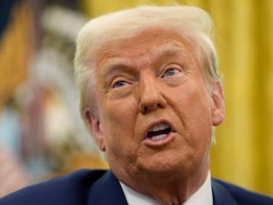 President Donald Trump speaks to reporters after signing an executive order in the Oval Office of the White House, Thursday, Feb. 13, 2025, in Washington