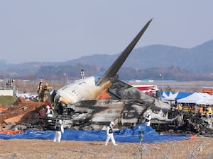 Rescue crews work near the wreckage of the plane at Muan airport in South Korea