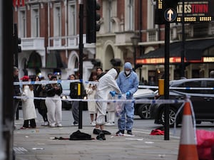 Forensic investigators collect evidence at the scene on Shaftesbury Avenue in central London