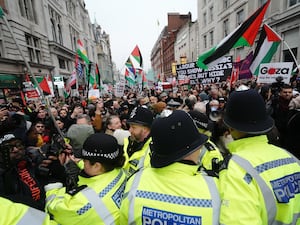 People breach a police line