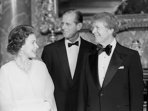 President Jimmy Carter joins the Queen and the Duke of Edinburgh at Buckingham Palace (Archive/PA)