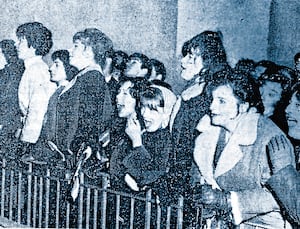 Beatles fans jockeying for a glimpse  of the group outside the Gaumont Cinema