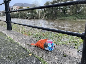 Flowers left by the river Cleddau in Haverfordwest following the incident (Bronwen Weatherby/PA)