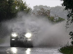 A car driving on a we road