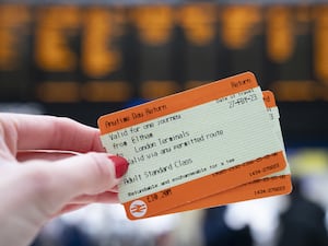 A woman holding train tickets