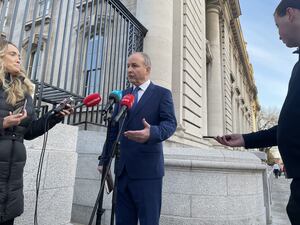 Taoiseach Micheal Martin talking to reporters outside Government Buildings