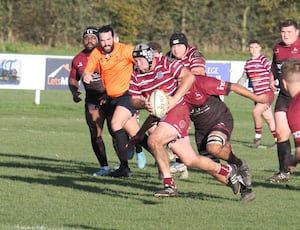 Newport Salop Rugby Club's Chris Taylor, pictured centre with the ball, helped save the life of a Rossendale coach. 