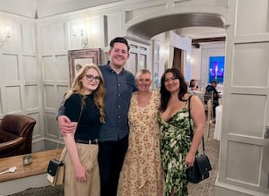 Nicola (peach flowery dress) with daughter Emily (green dress) at her living funeral