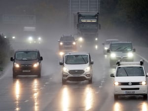 Cars driving in the rain with headlights on