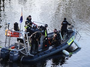 Police divers on a small boat