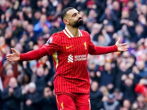 Liverpool's Mohamed Salah extends his arms in celebration