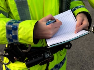 A police officer writes in her notebook