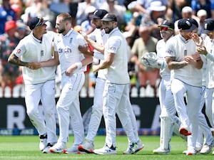 England bowler Gus Atkinson is congratulated by team-mate Brydon Carse, left, after taking a hat-trick against New Zealand