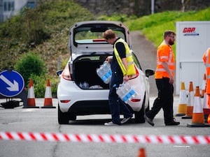 People collecting bottled water at Freshwater car park in Brixham