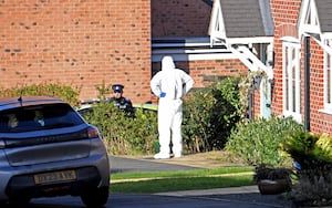 Forensic workers seen in Devereux Gardens, Great Haywood. 