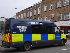 Police at the scene in Acton after a man was attacked by an armed gang after violence erupted near two barber shops