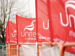 Row of Unite union flags along a fence