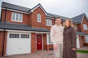 Honor Bailey and Lewis Williams standing in front of their newly purchased home at Bellway’s Darwin’s Edge development in Shrewsbury.