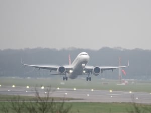 A plane takes off in foggy conditions from London Gatwick airport