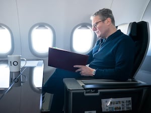 Prime Minister Sir Keir Starmer works on board a Government plane as he travels to Rio de Janeiro