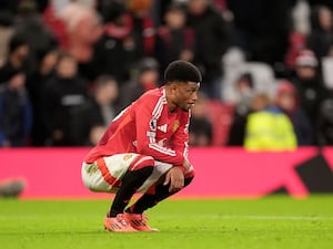 Manchester United’s Amad Diallo, who has suffered an ankle injury in training, crouches after a match.